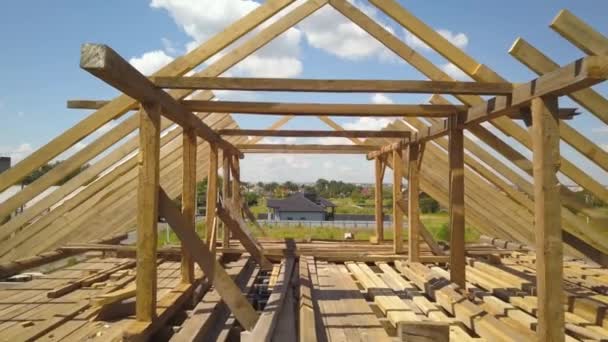 Aerial view of unfinished house with wooden roof frame structure under construction. — Stock Footage Aerial View Unfinished House Wooden Roof Frame Structure Construction Stock Footage