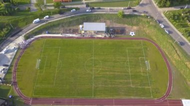 Kırsal bölgedeki yeşil çimlerle kaplı bir stadyumdaki futbol sahasının havadan görünüşü..
