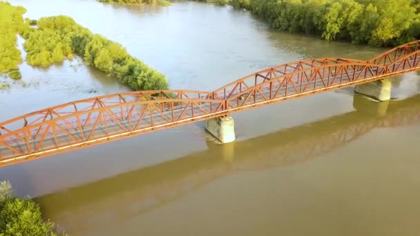 绿色农村地区泥泞宽阔河流上一座狭窄桥梁的空中景观 — 图库视频影像