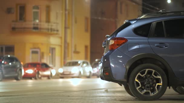 Blue Car Parked Brightly Illuminated City Street Moving Traffic Lights — Stock Video