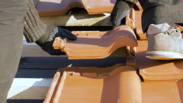 Closeup of worker hands installing yellow ceramic roofing tiles mounted on wooden boards covering residential building roof under construction. — Stock Footage Closeup Worker Hands Installing Yellow Ceramic Roofing Tiles Mounted Wooden Royalty Free Stock Video