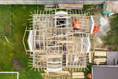Havalandırmalı beton duvarları ve ahşap çatısı olan özel bir evin havadan görüntüsü..