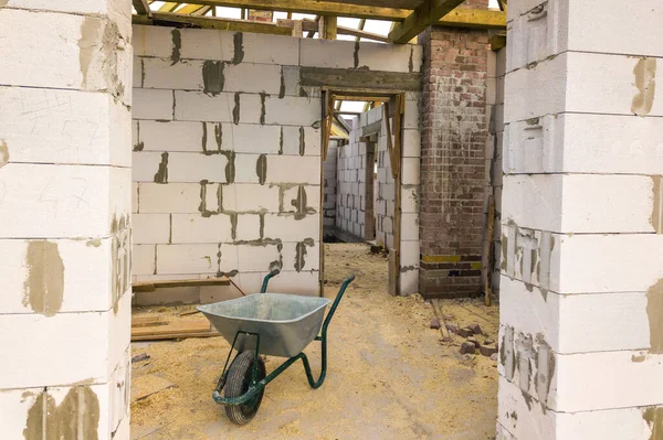 Interior of a private house with aerated concrete brick walls and wooden frame for future roof.