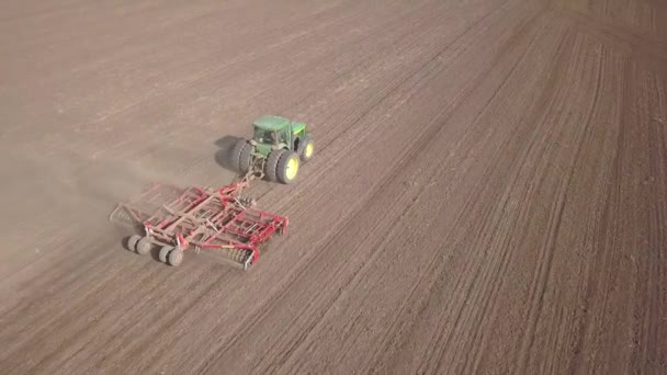 Top Aerial View Green Tractor Cultivating Ground Seeding Dry Field — Stock Video