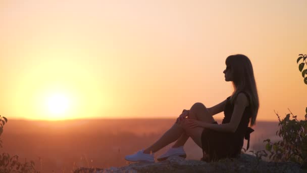 Young Elegant Woman Black Short Dress Sitting Rock Relaxing Outdoors — Stock Video