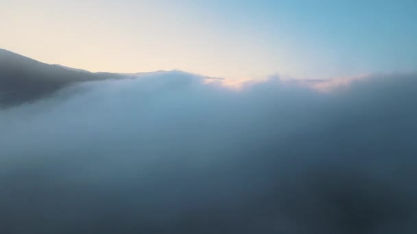 霧の上の風景の空中ビュー日没時に山の丘をカバー高速移動雲 — ストック動画