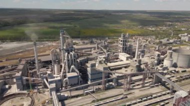Yüksek beton yapısı olan çimento fabrikasının havadan görünüşü ve endüstriyel üretim alanında kule vinci. Üretim ve küresel sanayi kavramı.