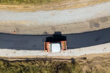 Buhar silindirli yeni yol inşaatının havadan görüntüsü.