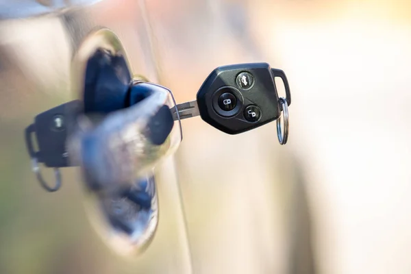 Stock image Close up of car door with key sticking out of the lock. Concept of process opening or closing vehicle.