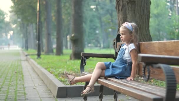 Little Serious Child Girl Sitting Alone Bench Summer Park — Stock Video