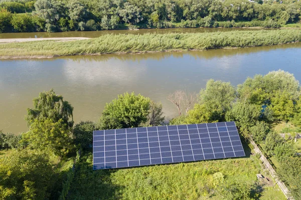 クリーンな生態系電気を生成するための裏庭の地面に取り付けられた青い太陽光発電パネルの空中ビュー 再生可能エネルギーの概念の生産 — ストック写真