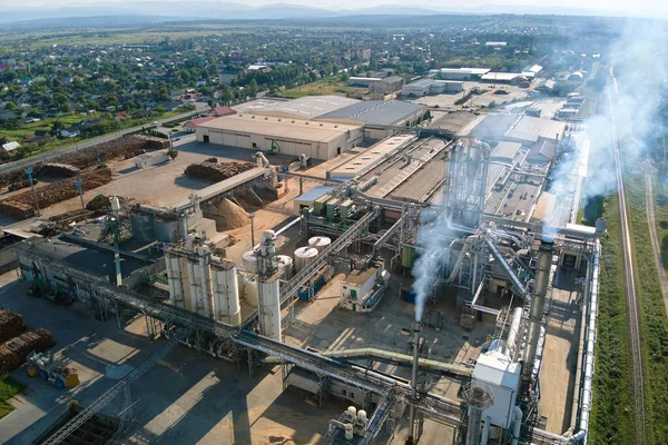 Aerial view of wood processing factory with stacks of lumber at plant manufacturing yard.