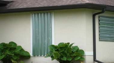 Kasırga hasarından korunmak için Florida 'daki evin camlarına çelik paneller monte edilmiş. Fırtına hazırlığı ve ev koruması.