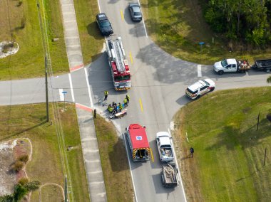 Florida 'da şehir caddesinde araba kazası. Dikkati dağılmış sürüş ve hız sonucu. ABD 'de araç ve bisiklet kazasında acil sağlık görevlileri.