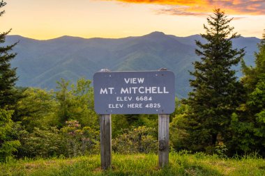 Kuzey Carolina Appalachian dağlarındaki Blue Ridge Parkway 'de araba yolculuğu. Mitchell Dağı Overlook yaz mevsiminde gün batımında. Güzel doğanın yaz manzarası.