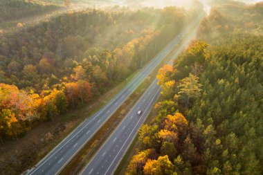 Sonbahar dağ tepeleri arasındaki otoban şeritlerinin yükseltilmiş görüntüsü. ABD 'de eyaletler arası ulaşım altyapısı.