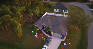 Festive yard display with glowing lights and Christmas decorations at a Florida family home. New Year holiday joy