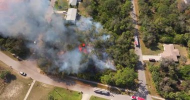 İtfaiyeciler ve itfaiye araçları yanan evleri kontrol altına almak için yarışıyor..