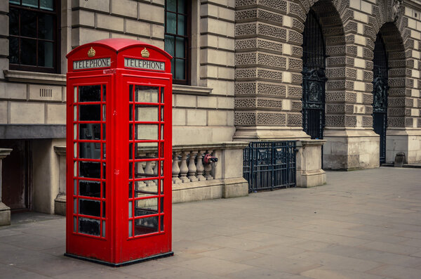 london, uk-circa september 2017: red telephone booth in the street of westminster, england, united