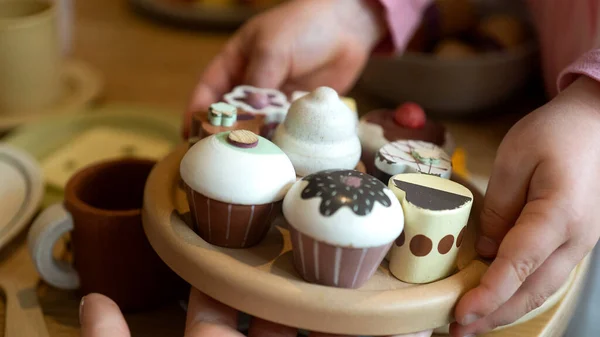 Wooden cupcakes on a tray in childrens handles — Photo