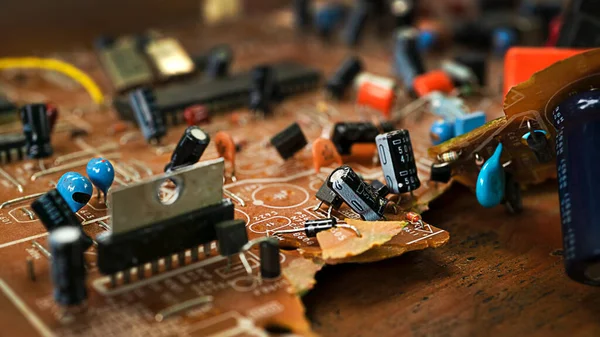 Old broken brown microcircuit close-up, old technology — Stock Photo, Image