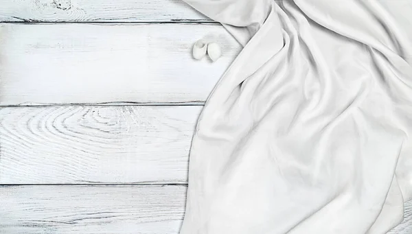 White silk fabric on white wooden background with copy space — Stock Photo, Image