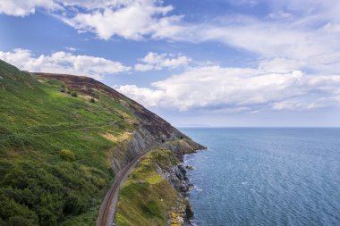 Stone rocks mountain path and railway at Irish seacoas clipart