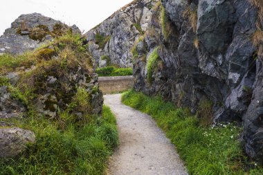 Stone rocks mountain hiking path at Irish seacoast. Bray, Greystone clipart