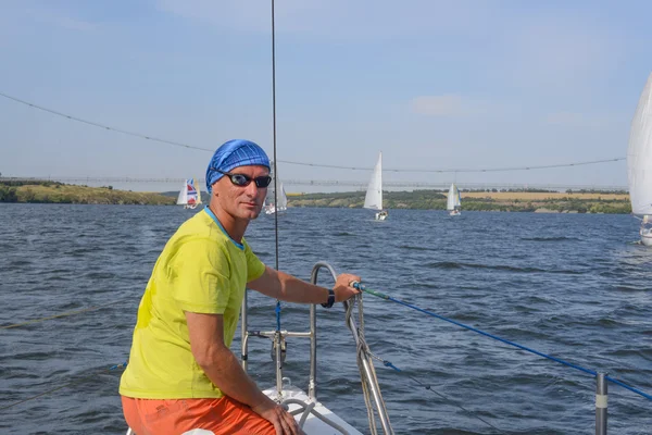 Active man resting on the yacht.