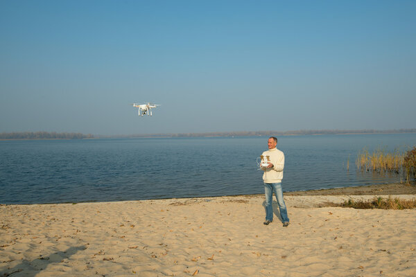 Dnepropetrovsk Ukraine, November 5, 2015: Man controls quadrocop