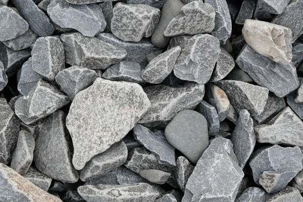 Decorative stone building pebbles close-up macro photo stone designer background. Gray Marble Shingle.