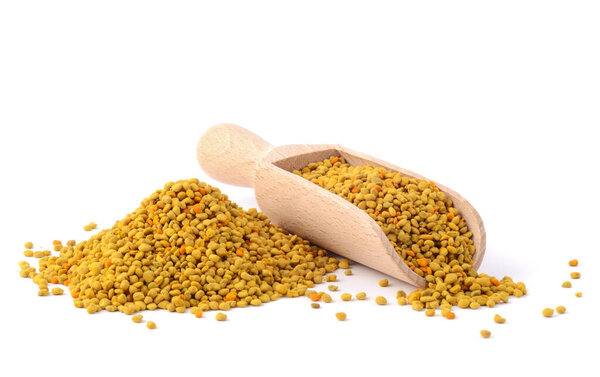 Flower bee pollen and a wooden slove is isolated on a white background. Natural remedy for immunity enhancement. Beekeeping products. Apitherapy