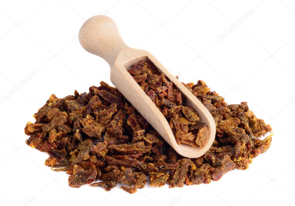 Propolis granules in a wooden shovel are isolated on a white background. Bee glue. Bee products. Apitherapy