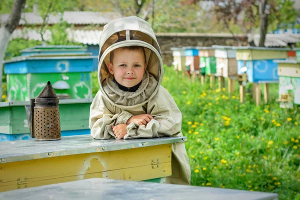 保護服の養蜂家の少年は猿の上で働く — ストック写真