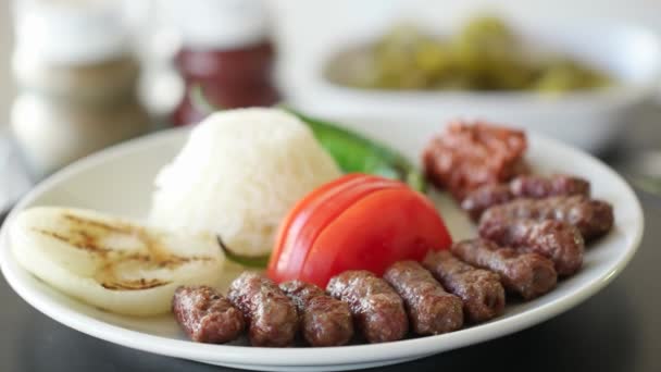 Boulette de viande turque inegol kofte avec riz, oignon, tomates et poivron vert. Tir rotatif. Ralentissez et fermez. Boucle sans couture . — Video