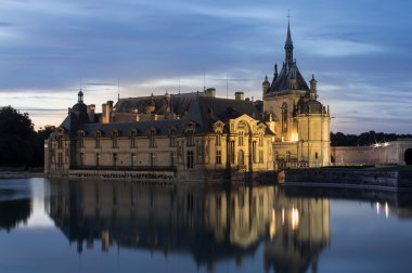 Castle of Chantilly at dusk clipart