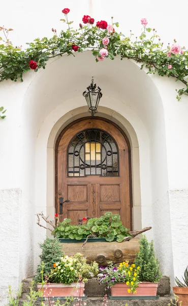 Holztür mit Rosen geschmückt — Stockfoto