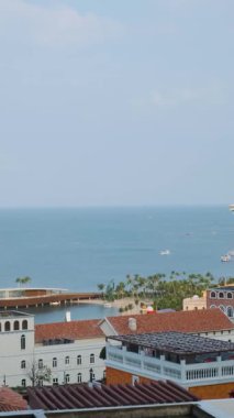Mediterranean style coastal town with colorful buildings and tall clock tower in Sunset Town, Phu Quoc island, Vietnam. Italian architecture in Asia. Vertical orientation. Travel and touristic