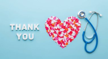A heartfelt thank you message with a heart shape and stethoscope on a blue background. Perfect for expressing gratitude to healthcare workers and medical professionals.