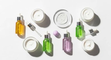 Overhead shot displays an assortment of skincare products, including creams, serums, and oils. The composition is clean, modern, and inviting, ideal for beauty promotions.