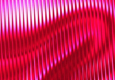 A close-up shot of corrugated metal sheet with a diagonal light and shadow effect. The red color and undulating pattern create a modern and industrial aesthetic.