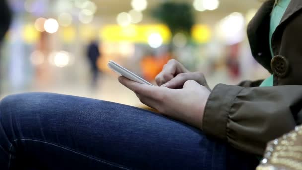 Mujer escribiendo en el teléfono inteligente en el centro comercial — Vídeos de Stock