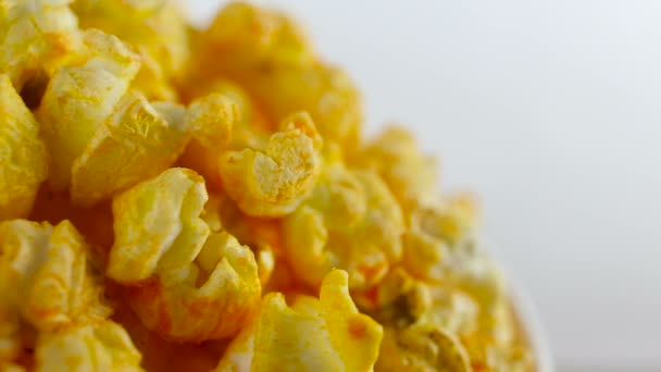 Cheese popcorn in box on white background, rotation, very close up — Stock Video
