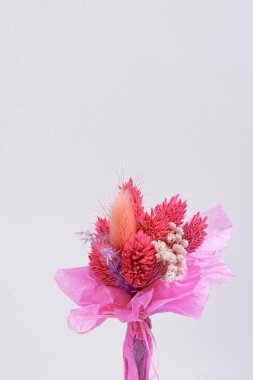 Mavi arkaplan üzerinde beyaz boş kağıt üzerinde küçük kırmızı istatik çiçeğin üst görünümü klasik tonda