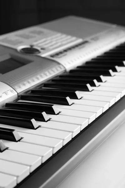 Electronic piano keyboards. Keyboard instrument. On a black background.