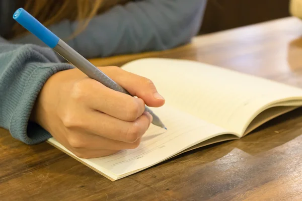 Kobiece ręce z napisem na notatniku — Zdjęcie stockowe