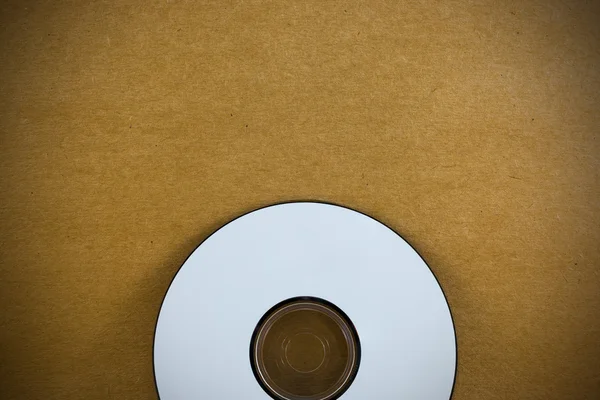 CD på trä papper bakgrundsstruktur — Stockfoto