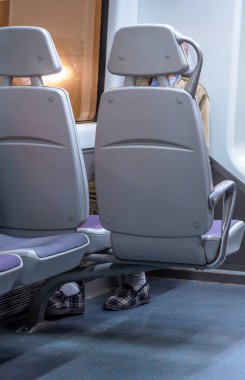 Alzheimer hastalığı olan yaşlı bir adam, toplum taşıma koltuğunda tek başına oturuyor. Kafası karıştığı için ayakkabı yerine terlik giyiyor..