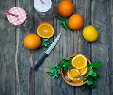 Yaz hazırlıkları, ferahlatıcı meyve içecekleri. Ahşap bir masada güveç ve aromatik otlar. Sağlıklı beslenme ve detoksifikasyon kavramı. Vitaminler.