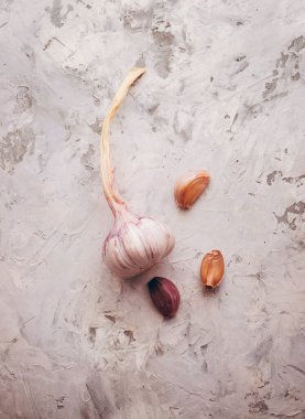 Sarımsaklı karanfil ve soğanlı sarımsaklı ampul. Taze sarımsaklı karanfil. Sağlıklı yaşam tarzı kavramı. Antiviral ve tıbbi sarımsak soğuk algınlığına ve gribe iyi gelir. Uzayı kopyala. Üst görünüm. Düz yatıyordu